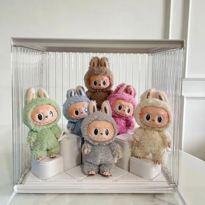 Collection of Labubu character plush toys in various pastel colors displayed in a transparent case